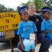 Safety Town graduates Averie Johnson, 5, and Breyana Jackson, 4, smile as they pose for a photo with Ann Arbor Police Sgt. Tom Hickey outside of at Dicken Elementary School on Friday, July, 26, 2013. Melanie Maxwell | AnnArbor.com